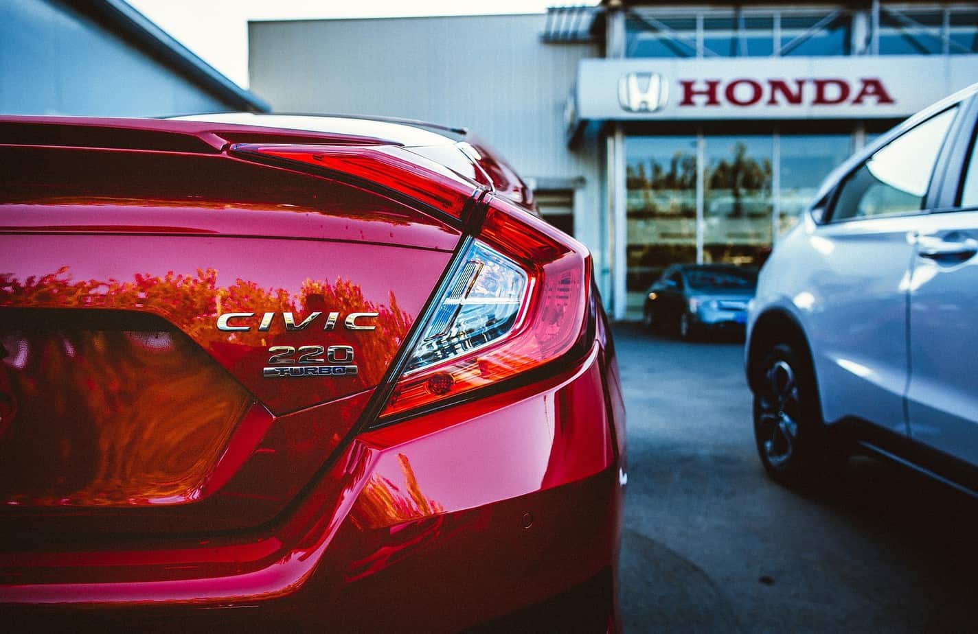 red honda in front of the japanese car dealer